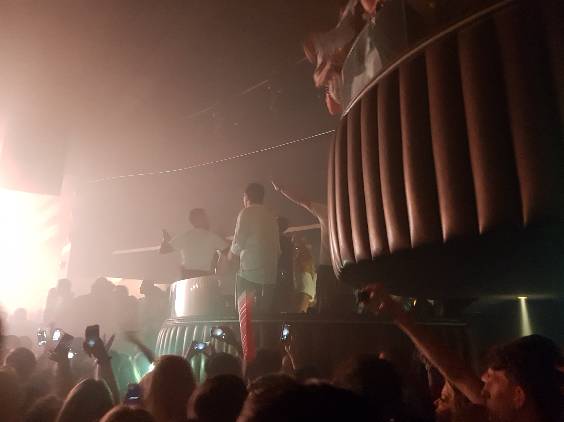 People Having Fun Inside the VIP Booth and Just Outside It